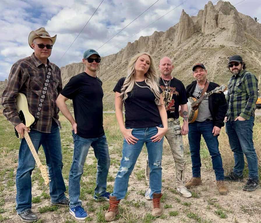Outdoor band performance at Friday Night Live event with scenic mountain backdrop.