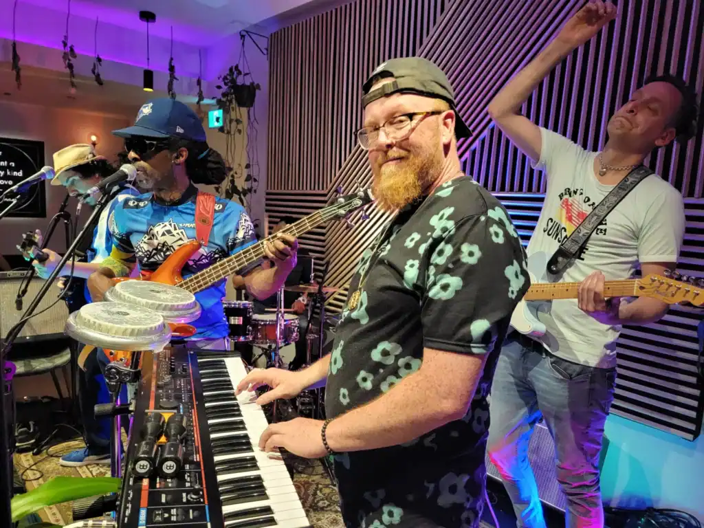Live band performing at Friday Night Live event with energetic musicians.