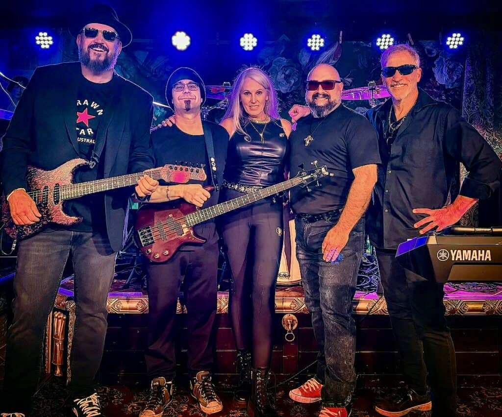 Live band performance at Friday Night Live event with musicians on stage.